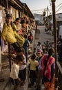 Children line up on stairs, balcony and street to watch foreigners here to film them