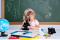 Children little girl at school with microscope Royalty Free Stock Photo