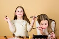 Children little girls make up face. Makeup store. Experimenting with style. Creativity is best makeup skill. Make up