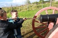 Children load ancient cannon