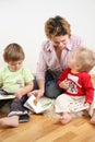 Children looking books with mother 2 Royalty Free Stock Photo