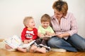 Children looking books with mother Royalty Free Stock Photo
