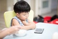 Children are looking mobile phone at home. Royalty Free Stock Photo