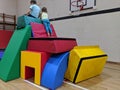 2 children looking over the edge of a soft play fort