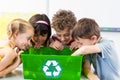 Children looking at plastic bottles in recycling box Royalty Free Stock Photo