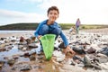 Children Looking In Rockpools On Winter Beach Vacation Royalty Free Stock Photo