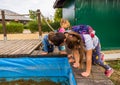 Children looking for something in a water pond in the Zaurolandia dinosaur park