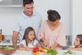 Children looking at their mother preparing vegetables Royalty Free Stock Photo