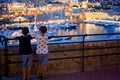 Children looking at the view of the Monaco harbor from the village in the evening Royalty Free Stock Photo