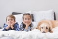 Preschooler children lying on a bed