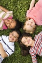 Children Lying in Clover With Heads Together