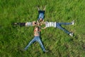 Children lying on the grass, happy and joyful brothers and sisters, top view