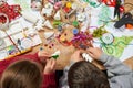 Children make crafts and toys, christmas tree and other. Painting watercolors. Top view. Artwork workplace with creative accessori Royalty Free Stock Photo