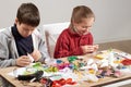 Children make crafts and toys, handmade concept. Artwork workplace with creative accessories. Royalty Free Stock Photo