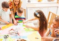 Children make greeting cards with their mothers in a masterclass