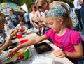 Children making cakes during Apple Feast Day