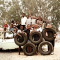 Children making Olympic Circles with tires in township, South Africa.