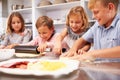 Children making pizza together Royalty Free Stock Photo