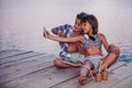 Children making selfie on a wooden pier, by the river Royalty Free Stock Photo