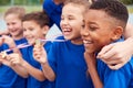 Children With Male Coach Showing Off Winners Medals On Sports Day