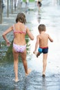 Children marching through a puddle Royalty Free Stock Photo