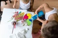 Children mixing colorful paints while painting Royalty Free Stock Photo