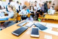 Children mobile phones stand on a teacher`s desk in a school class