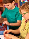 Children model from plasticine in school craft lesson