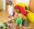 Children and mother collecting toys Royalty Free Stock Photo