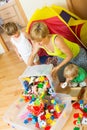 Children and mother collecting toys Royalty Free Stock Photo