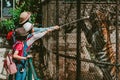 Children and mother feeding meat to big tiger in zoo Royalty Free Stock Photo