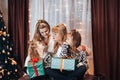 Children with mother and grandmother in their hands holding boxes with gifts in green packaging. Christmas mood. Celebrate the Royalty Free Stock Photo