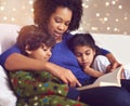 Children, mother and reading a book in a family home for story time on lounge sofa with bokeh. A woman or mom with kids Royalty Free Stock Photo