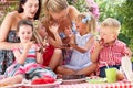 Children And Mothers Eating Cake At Outd Royalty Free Stock Photo