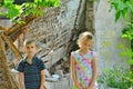 Children are near the ruined house, the concept of natural disaster, fire, and devastation. Royalty Free Stock Photo