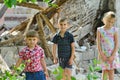 Children are near the ruined house, the concept of natural disaster, fire, and devastation. Royalty Free Stock Photo