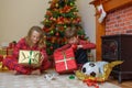 Children opening gifts on Christmas morning Royalty Free Stock Photo