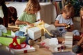 Children opening Xmas presents. Kids under Christmas tree with gift boxes Royalty Free Stock Photo