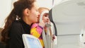 Children ophthalmology - optometrist Checks Child`s Eye