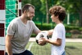 Sportive dad playing soccer with his son Royalty Free Stock Photo