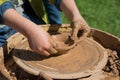 Children outdoor studying using pottery wheel Royalty Free Stock Photo