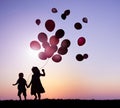 Children Outdoors Holding Balloons Together