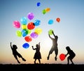 Children Outdoors Playing Balloons Together