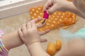 Children paint each other's nails with baby nail polish. Children's cosmetics.