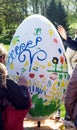 Children paint a large Easter eggs in the park