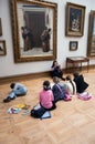 Children paint sitting on floor in the Tretyakov Gallery in Moscow Royalty Free Stock Photo