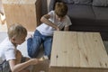 Children paint wooden pedestal. Two brothers help make the table. Joinery. Carpentry workshop