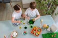 Children painting colorful eggs for easter holidays at home