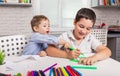 Children are painting in kindergarten. Kids draw at home together. Royalty Free Stock Photo