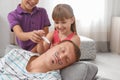 Children painting their father`s face while he sleeping Royalty Free Stock Photo